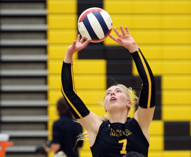 Metea Valley's Katie Schuele sets the ball during game against Yorkville in Aurora on Wed, Sept. 11, 2024. (James C. Svehla / Beacon News)