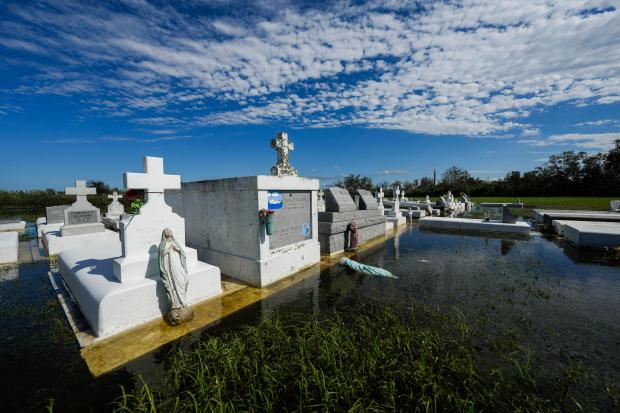 Tombs are seen after being disturbed by flooding, in the aftermath of Hurricane Francine, in Dulac, La., Thursday, Sept. 12, 2024. (AP Photo/Gerald Herbert)