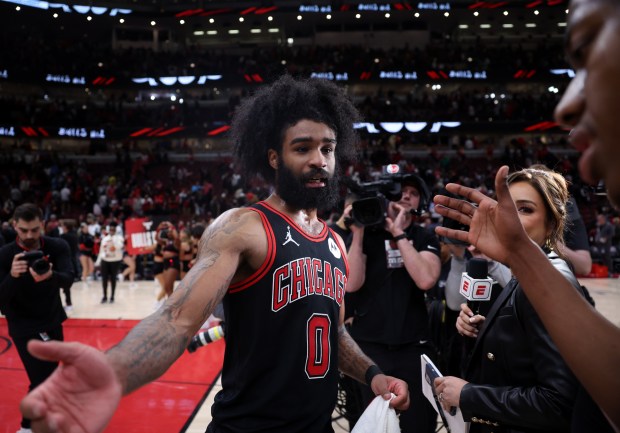 Bulls guard Coby White celebrates with teammate Ayo Dosunmu after a Play-In Tournament win over the Hawks at the United Center on April 17, 2024. (Chris Sweda/Chicago Tribune)