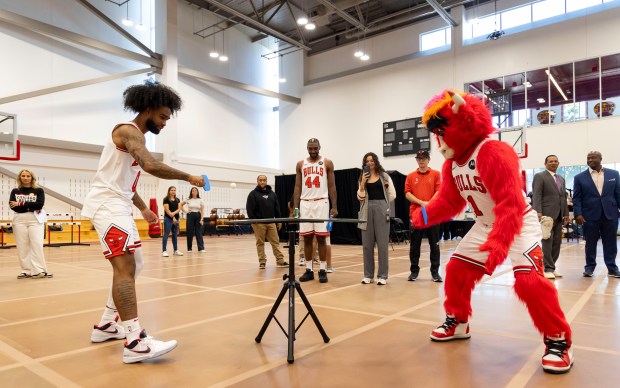 Coby White plays pingpong against Benny the Bull on Monday, Sept. 30, 2024, during Bulls media day at the Advocate Center. (Brian Cassella/Chicago Tribune)