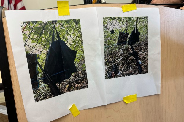 Photos that show an AK-47 rifle, a backpack and a Go-Pro camera on a fence outside Trump International Golf Club taken after an apparent assassination attempt of Republican presidential candidate former President Donald Trump, are displayed during a news conference at the Palm Beach County Main Library, Sept. 15, 2024, in West Palm Beach, Fla. (Stephany Matat/AP)