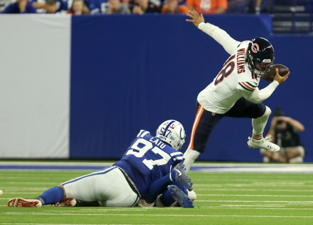 Bears quarterback Caleb Williams is pressured by Colts defensive end Laiatu Latu during the 1st quarter at Lucas Oil Stadium on Sept. 22, 2024, in Indianapolis (Stacey Wescott/Chicago Tribune)