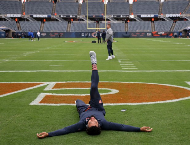 Chicago Bears quarterback Caleb Williams stretches in the end zone as he warms up to face the Los Angeles Rams on Sunday, Sept. 29, 2024, at Soldier Field. (Brian Cassella/Chicago Tribune)