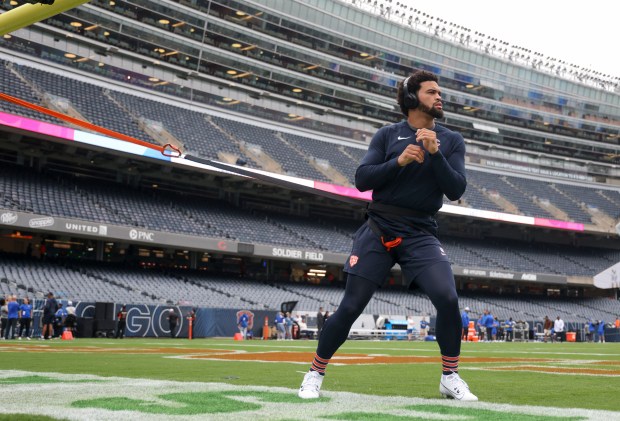 Chicago Bears quarterback Caleb Williams stretches in the end zone as he warms up to face the Los Angeles Rams. (Brian Cassella/Chicago Tribune)