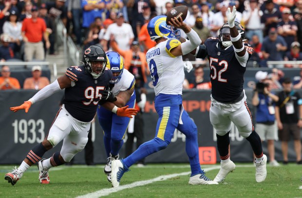 Los Angeles Rams quarterback Matthew Stafford throws an interception to end the game under pressure from Chicago Bears defensive ends DeMarcus Walker (95) and Darrell Taylor (52) in the fourth quarter Sunday, Sept. 29, 2024, at Soldier Field. (Brian Cassella/Chicago Tribune)