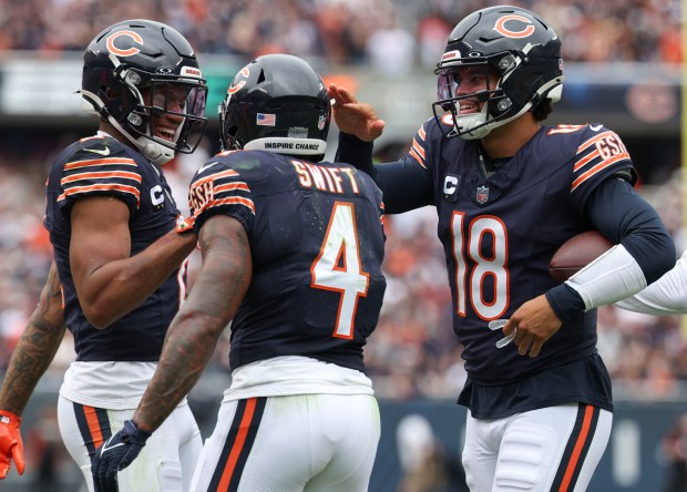 Chicago Bears quarterback Caleb Williams (18) celebrates his touchdown pass to DJ Moore (left) against the Los Angeles Rams in the third quarter on Sunday, Sept. 29, 2024, at Soldier Field. (Brian Cassella/Chicago Tribune)