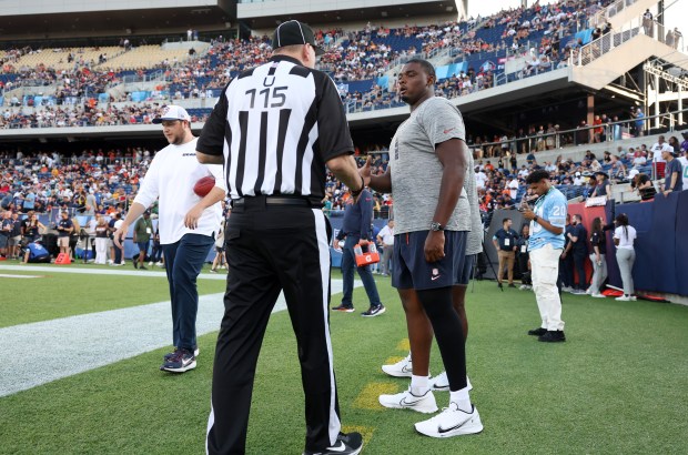 Bears lineman Kiran Amegadjie is greeted by an official before the Hall of Fame Game against the Texans at Tom Benson Hall of Fame Stadium on Aug. 1, 2024, in Canton. (John J. Kim/Chicago Tribune)