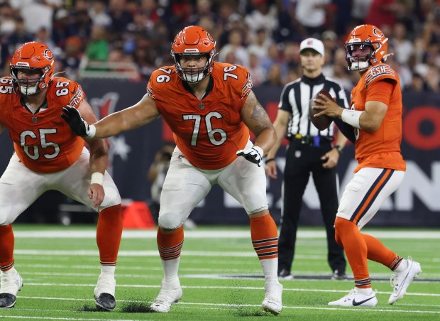 Bears center Coleman Shelton (65) and guard Teven Jenkins (76) protect quarterback Caleb Williams in the second quarter against the Texans on Sept. 15, 2024, in Houston. (John J. Kim/Chicago Tribune)