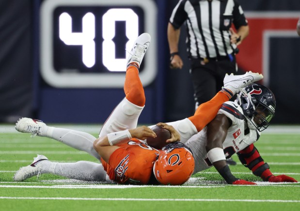 Bears quarterback Caleb Williams is sacked by Texans linebacker Azeez Al-Shaair in the fourth quarter at NRG Stadium on Sept. 15, 2024, in Houston. (John J. Kim/Chicago Tribune)