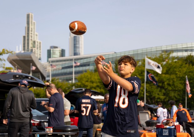 Javie Lents celebrates his 11th birthday throwing a football outside before the Chicago Bears face the Tennessee Titans in the season opener on Sunday, Sept. 8, 2024, at Soldier Field. (Brian Cassella/Chicago Tribune)