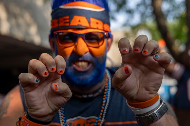 Jeremy Schmidt shows off his Bear Down fingernails while tailgating before the Chicago Bears face the Tennessee Titans in the season opener on Sunday, Sept. 8, 2024, at Soldier Field. (Brian Cassella/Chicago Tribune)