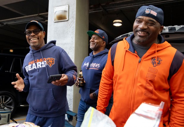 Friends Jaye Beasley, Bruce Davis and Ed Fairchild tailgate together before the Chicago Bears face the Tennessee Titans in the season opener on Sunday, Sept. 8, 2024, at Soldier Field. (Brian Cassella/Chicago Tribune)a