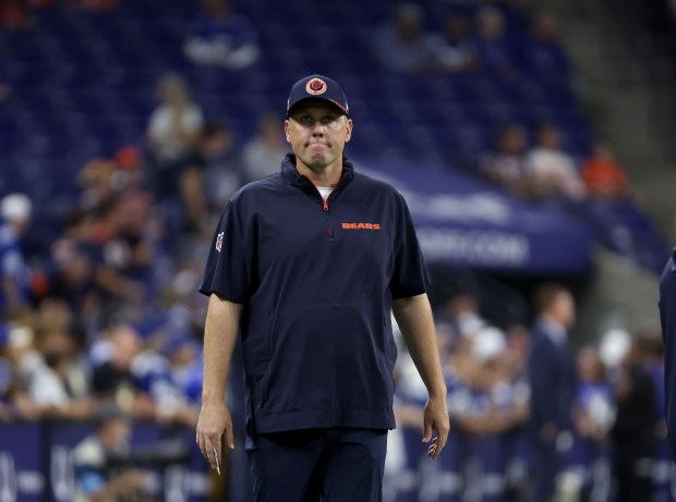 Bears offensive coordinator Shane Waldron walk around the field before a game against the Colts on Sept. 22, 2024, at Lucas Oil Stadium in Indianapolis. (Stacey Wescott/Chicago Tribune)