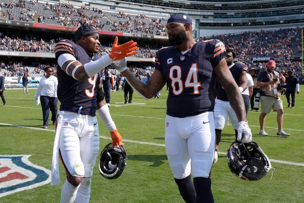 Bears safety Jaquan Brisker (9) and tight end Marcedes Lewis celebrate the team's 24-17 win over the Titans on Sept. 8, 2024, at Soldier Field. (AP Photo/Nam Y. Huh)