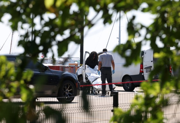 Guns and victims still remained on the scene as Chicago police investigate an early morning shooting near the 31st Street Beach on Friday June 21, 2024 (Antonio Perez/Chicago Tribune)