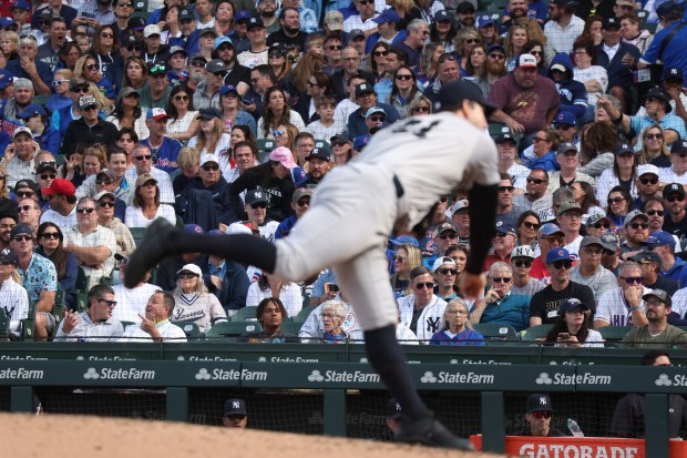 A fair amount of Yankees fans are seen in the stands as pitcher Jake Cousins delivers against the Cubs in the eighth inning on Sept. 6, 2024, at Wrigley Field. (Terrence Antonio James/Chicago Tribune)