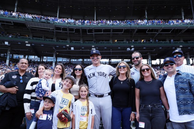 Yankees first baseman Anthony Rizzo (48) poses for photos with family and friends as he is welcomed back to Wrigley Field before the start of a game against the Cubs on Sept. 6, 2024. (Terrence Antonio James/Chicago Tribune)