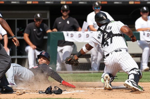 Guardians second baseman Andrés Giménez, left, slides to escape the tag by White Sox catcher Chuckie Robinson to score in the third inning at Guaranteed Rate Field on Sept. 11, 2024, in Chicago. (John J. Kim/Chicago Tribune)