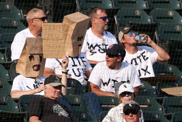 A group of fans wear matching T-shirts and paper bags over their heads in the ninth inning between the White Sox the Guardians at Guaranteed Rate Field on Sept. 11, 2024, in Chicago. (John J. Kim/Chicago Tribune)