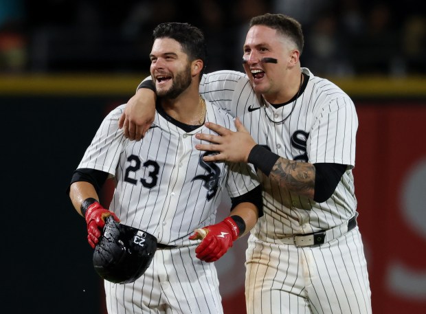 White Sox left fielder Andrew Benintendi (23) celebrates with catcher Korey Lee after hitting a game-winning RBI single for a 4-3 win against the Angels in the tenth inning at Guaranteed Rate Field on Sept. 25, 2024, in Chicago. (John J. Kim/Chicago Tribune)