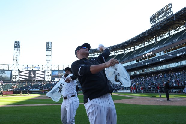 White Sox second baseman Lenyn Sosa, left, and player Gavin Sheets toss T-shirts to fans after a 7-0 win over the Angels at Guaranteed Rate Field on Sept. 26, 2024, in Chicago. The White Sox swept the series 3-0. (John J. Kim/Chicago Tribune)