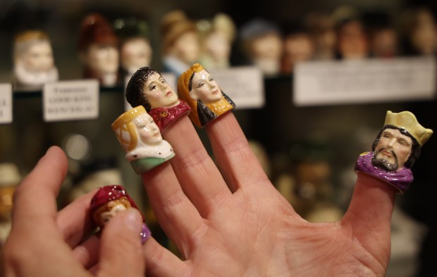 Beth Mullins Scales, the daughter of Steve Mullins who founded the American Toby Jug Museum, puts on Toby jug thimbles in Evanston on Sept. 17, 2024. (Stacey Wescott/Chicago Tribune)