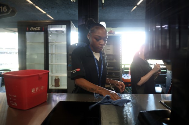 Destiny Boldon begins cleaning a concessions booth after a 7-0 White Sox win over the Angels in the final home game of the season at Guaranteed Rate Field on Sept. 26, 2024. (John J. Kim/Chicago Tribune)