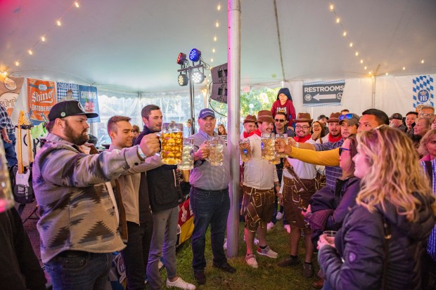 People participate in a stein-holding competition at Oktoberfest at Naper Settlement. (Naperville Heritage Society)