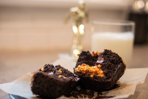 A gold medal chocolate muffin stuffed with peanut butter is ready alongside a glass of milk on Aug. 29, 2024, in Chicago. (Vincent D. Johnson/for the Chicago Tribune)