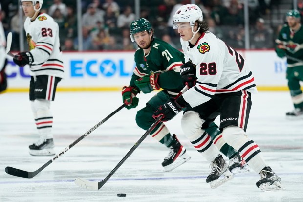 Blackhawks center Colton Dach skates with the puck against the Wild during a preseason game on Oct. 6, 2022, in St. Paul, Minn. (AP Photo/Abbie Parr)