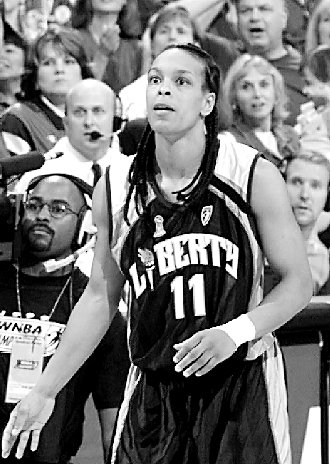 The New York Liberty's Teresa Weatherspoon watches her shot from beyond midcourt go in at the buzzer to beat the Houston Comets 68-67 in Game 2 of the WNBA Finals on Sept. 4, 1999, in Houston. (AP Photo/David J. Phillip)