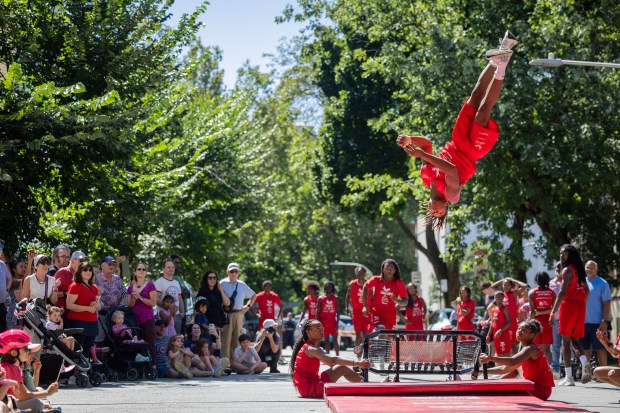 Members of the Jesse White Tumbling Team perform during the WOOGMS parade in the Lakeview neighborhood of Chicago on Sept. 2, 2024. (Tess Crowley/Chicago Tribune)