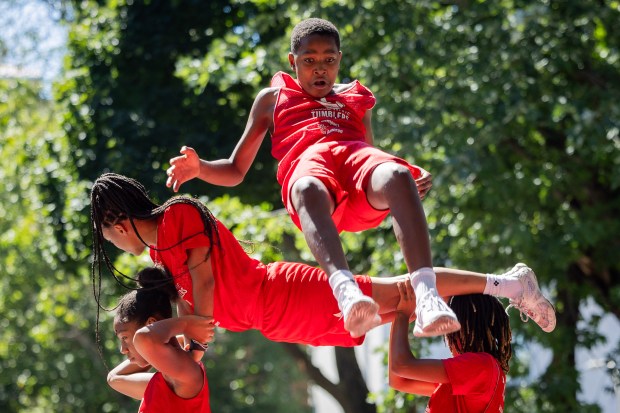 Members of the Jesse White Tumbling Team perform at the WOOGMS parade in the Lakeview neighborhood of Chicago on Sept. 2, 2024. (Tess Crowley/Chicago Tribune)