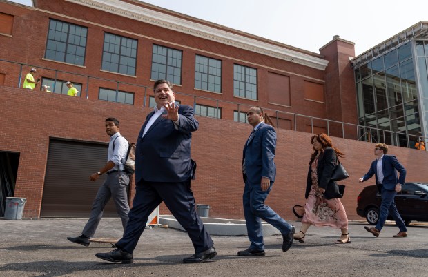 Gov. JB Pritzker departs after an announcement about JPMorgan Chase committing $10 million in low-interest loans to advance affordable housing development on Chicago's South and West sides on Sept. 10, 2024, at the future site of the Aspire Center for Workforce Innovation inside the shuttered Emmet Elementary School in Austin. (Brian Cassella/Chicago Tribune)