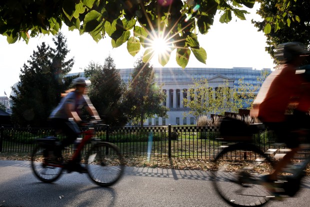 Cyclists travel by Soldier Field on the lakefront bike path on Sept. 18, 2024. (Chris Sweda/Chicago Tribune)