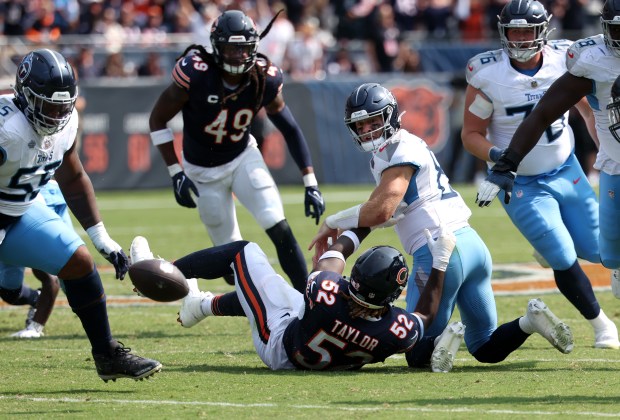 Titans quarterback Will Levis looks back at a fumbled ball after getting sacked by Bears defensive end Darrell Taylor (52) in the fourth quarter at Soldier Field on Sept. 8, 2024. (Chris Sweda/Chicago Tribune)