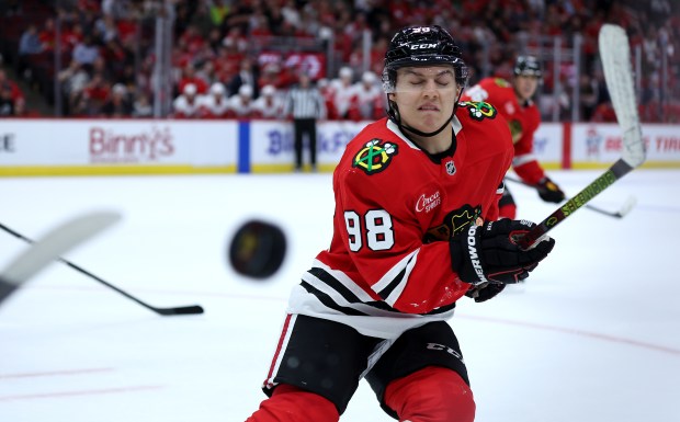 Blackhawks center Connor Bedard shuts his eyes as a puck flies by in the third period of a preseason game against the Red Wings on Sept. 25, 2024, at the United Center. (Chris Sweda/Chicago Tribune)