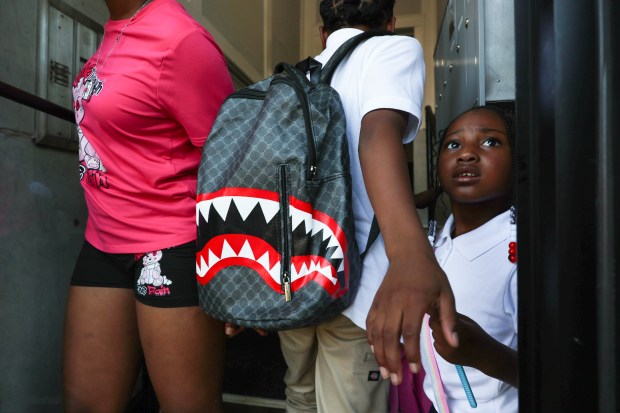 Jariyah Cook, 4, right, waits as her siblings walk through the door to their grandmother's home after school on Tuesday, Aug. 27, 2024, in Chicago. Jariyah's father, Joseph Cook, was fatally shot last week. (John J. Kim/Chicago Tribune)