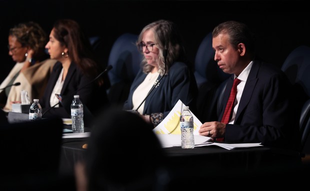 Chicago Public Schools CEO Pedro Martinez, right, listens in during the public comment portion of a board meeting at Roberto Clemente Community Academy in Chicago on Thursday, Sept. 26, 2024. (Chris Sweda/Chicago Tribune)