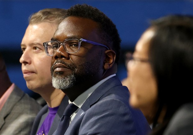 Chicago Public Schools CEO Pedro Martinez, left, and Mayor Brandon Johnson and others gather for a rally celebrating several dozens of Chicago Public Schools Safe Passage employees at Wintrust Arena on Tuesday, Aug. 15, 2023. (Antonio Perez/Chicago Tribune)