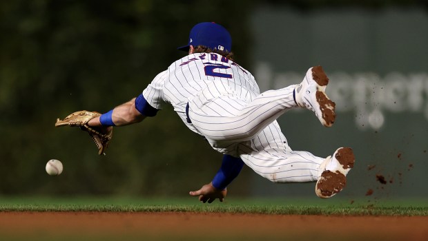 Cubs second base Nico Hoerner dives but is unable to come up with a ground ball that went for a single in the second inning against the Nationals on Sept. 19, 2024, at Wrigley Field. (Chris Sweda/Chicago Tribune)