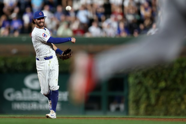 Chicago Cubs shortstop Dansby Swanson makes a throw to first base after making a force out at second base in the second inning of a game against the Washington Nationals at Wrigley Field in Chicago on Sept. 19, 2024. (Chris Sweda/Chicago Tribune)