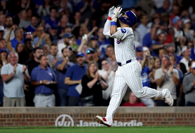 Chicago Cubs right fielder Seiya Suzuki celebrates as he trots toward home plate after hitting a 2-run home run in the third inning of a game against the Washington Nationals at Wrigley Field in Chicago on Sept. 19, 2024. (Chris Sweda/Chicago Tribune)