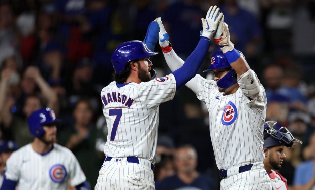 Chicago Cubs right fielder Seiya Suzuki (right) is congratulated by teammate Dansby Swanson after Suzuki hit a 2-run home run in the third inning of a game against the Washington Nationals at Wrigley Field in Chicago on Sept. 19, 2024. (Chris Sweda/Chicago Tribune)