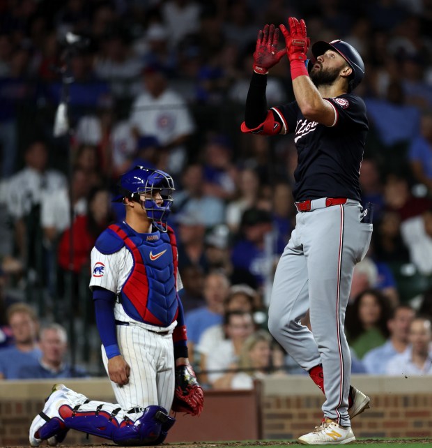 Washington Nationals right fielder Joey Gallo celebrates beside Chicago Cubs catcher Miguel Amaya at home plate after hitting a 3-run home run off of Drew Smyly in the sixth inning of a game at Wrigley Field in Chicago on Sept. 19, 2024. (Chris Sweda/Chicago Tribune)