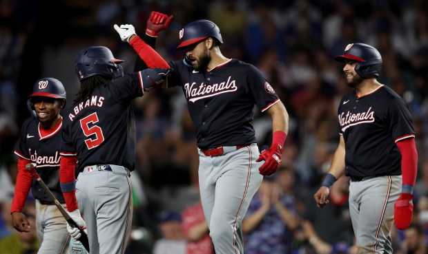 Washington Nationals right fielder Joey Gallo (second from right) is congratulated by his teammates after hitting a 3-run home run off of Chicago Cubs relief pitcher Drew Smyly in the sixth inning of a game at Wrigley Field in Chicago on Sept. 19, 2024. (Chris Sweda/Chicago Tribune)