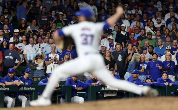 Chicago Cubs fans look on as Chicago Cubs relief pitcher Porter Hodge delivers to the Washington Nationals in the ninth inning of a game at Wrigley Field in Chicago on Sept. 19, 2024. (Chris Sweda/Chicago Tribune)