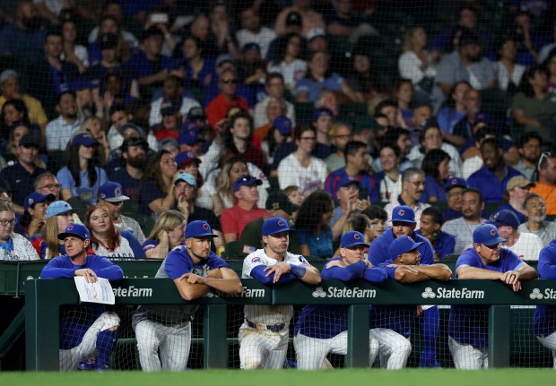 Cubs manager Craig Counsell, left, alongside his coaching staff and players, looks out of the dugout in the ninth inning against the Nationals on Sept. 19, 2024, at Wrigley Field. (Chris Sweda/Chicago Tribune)