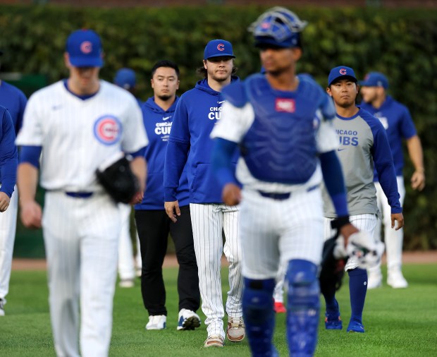 Chicago Cubs pitcher Justin Steele (center) walks behind fellow pitcher Kyle Hendricks and catcher Christian Bethancourt before a start by Hendricks against the Pittsburgh Pirates at Wrigley Field in Chicago on Sept. 3, 2024. (Chris Sweda/Chicago Tribune)