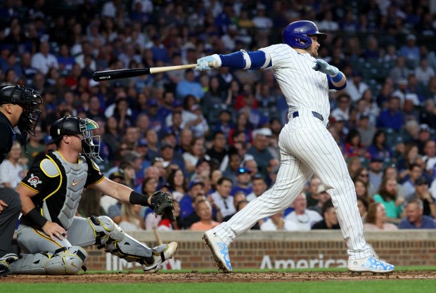 Chicago Cubs left fielder Ian Happ (8) drives in two runs on a single in the second inning of a game against the Pittsburgh Pirates at Wrigley Field in Chicago on Sept. 4, 2024. (Chris Sweda/Chicago Tribune)